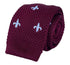 maroon knitted tie with white embroidered fleur de lis lys design